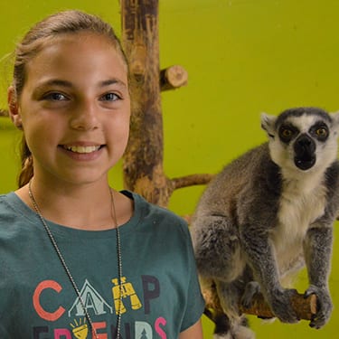 Adopt An Animal Jungle - Camper with ring tail lemur - Cub Creek Science and Animal Camp