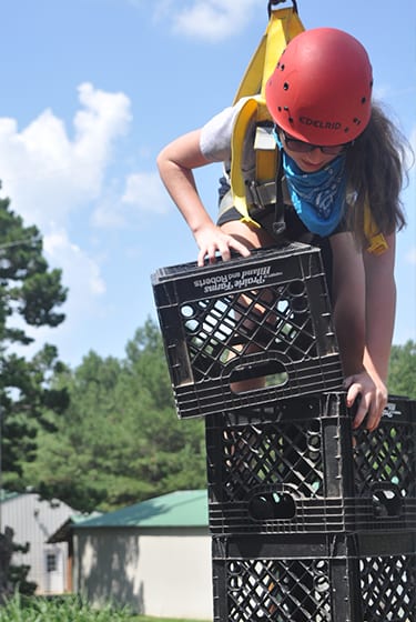 Adventure At Camp - Camper on ropes course crate stacking - Cub Creek Science and Animal Camp