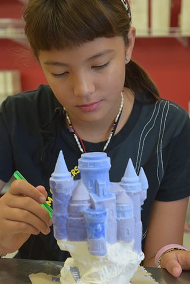 Arts & Crafts At Camp - Camper painting castle ceramics - Cub Creek Science and Animal Camp