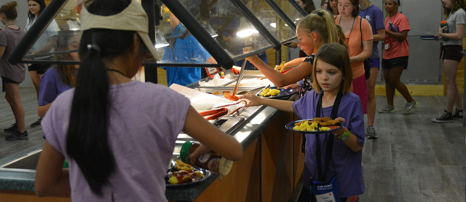 Camp Meals - Campers getting food at buffet bar - Cub Creek Science and Animal Camp