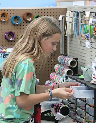 Camp Store - Camper looking through camp store items - Cub Creek Science and Animal Camp