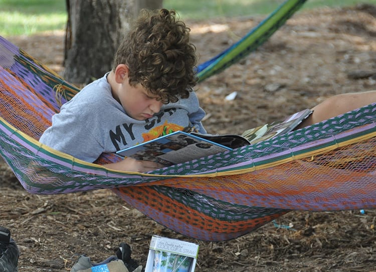 Free Time - Camper reading in the hammocks - Cub Creek Science and Animal Camp