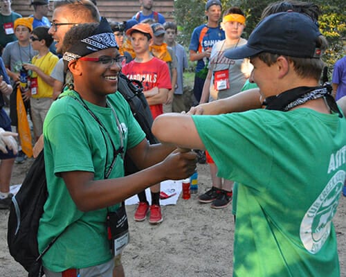 Leadership Programs - ASIT campers playing games at opening campfire - Cub Creek Science and Animal Camp