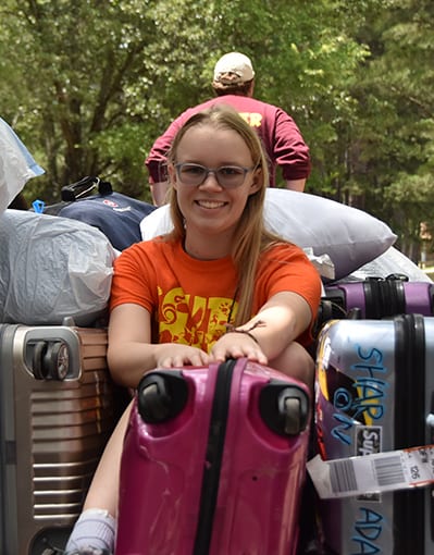 Lost And Found - ASIT camper helping move luggage on check in day - Cub Creek Science and Animal Camp