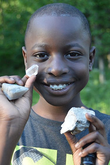 Nature At Camp - Camper showing off gemstones - Cub Creek Science and Animal Camp