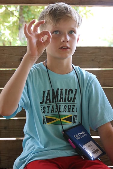 Science At Camp - Camper learning sign language - Cub Creek Science and Animal Camp