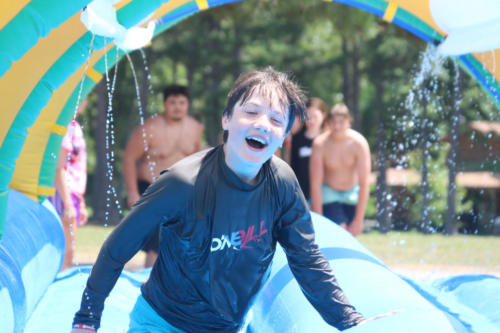 Camper having fun on inflatable - Cub Creek Science Camp 